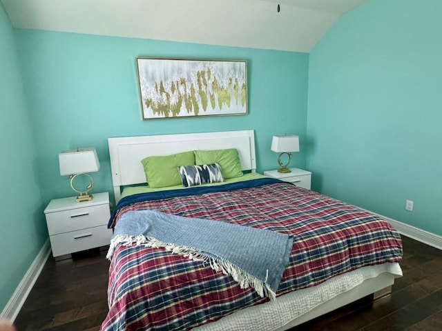 bedroom featuring baseboards, vaulted ceiling, and dark wood finished floors