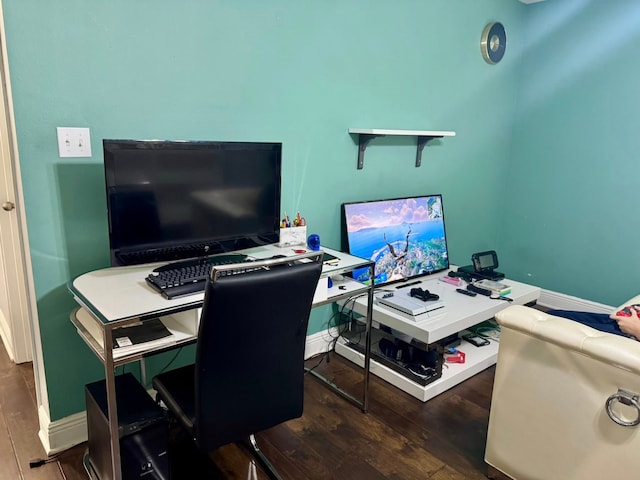 office space featuring baseboards and wood finished floors