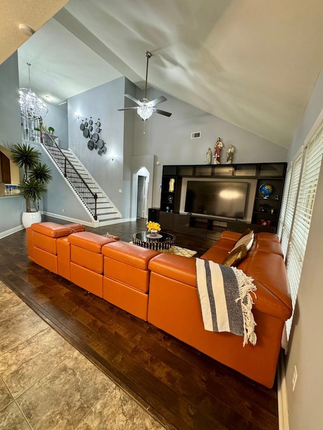 living room with visible vents, lofted ceiling, ceiling fan, stairway, and hardwood / wood-style flooring