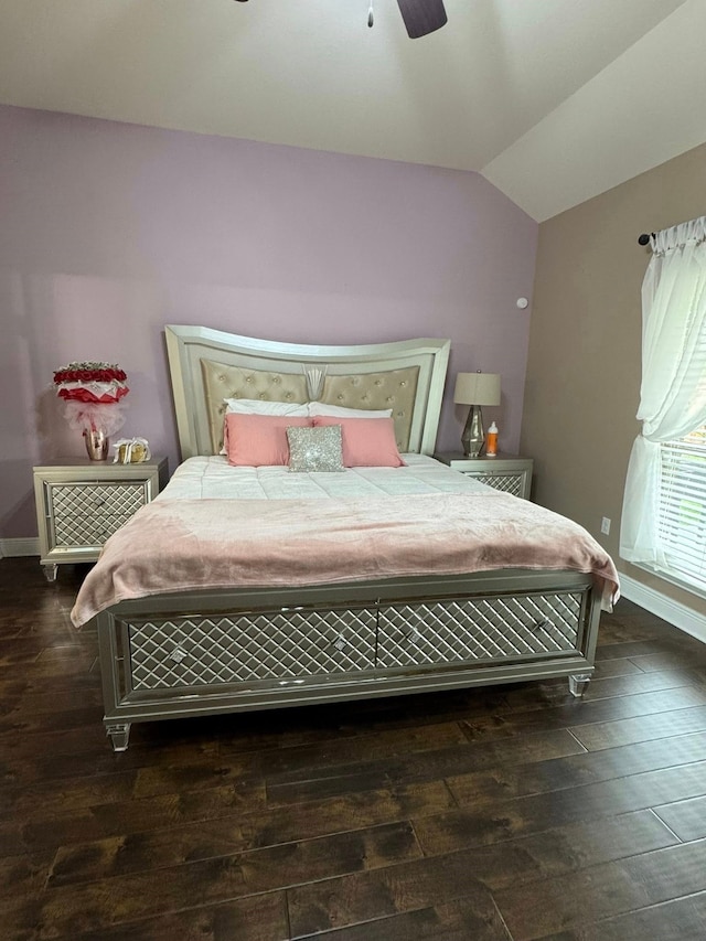 bedroom with wood-type flooring, a ceiling fan, baseboards, and vaulted ceiling