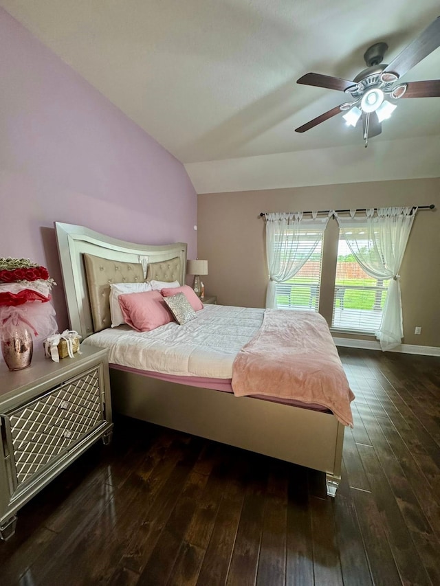 bedroom with a ceiling fan, vaulted ceiling, and hardwood / wood-style floors