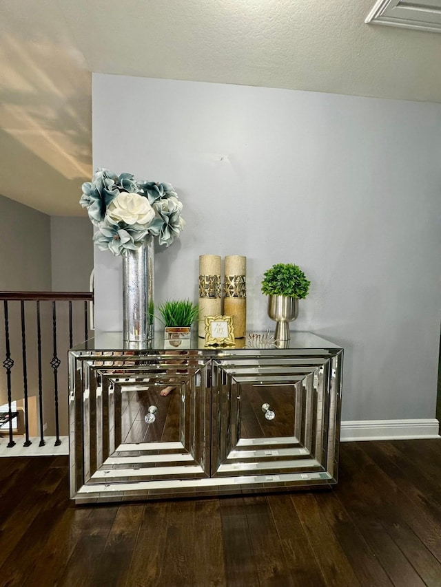 interior details featuring baseboards and wood finished floors