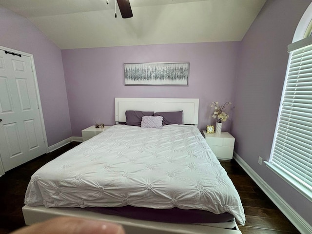 bedroom with baseboards, a ceiling fan, vaulted ceiling, and wood finished floors