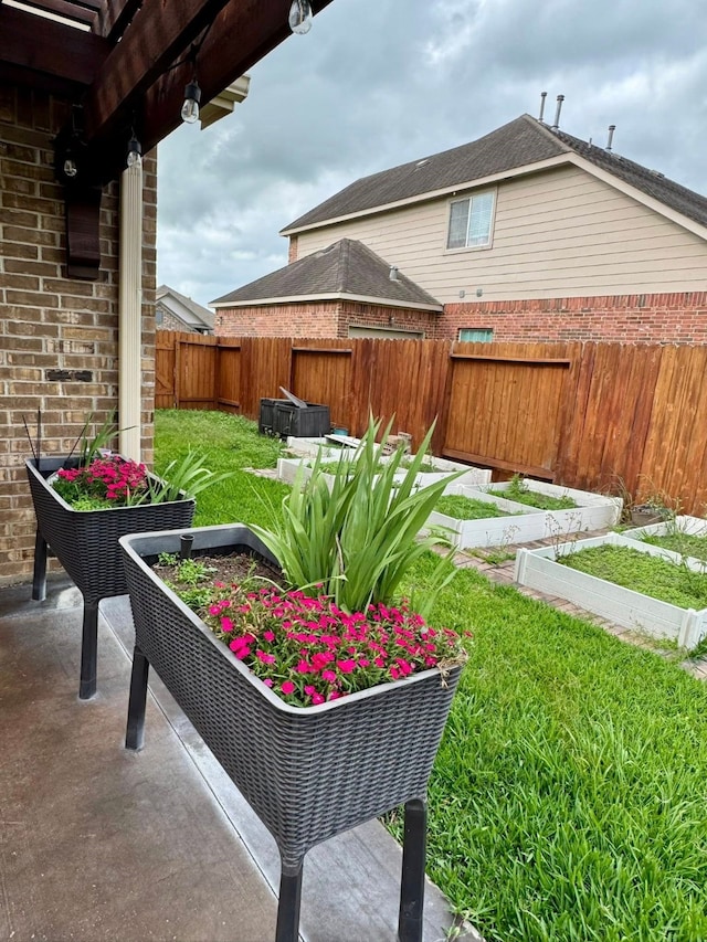 view of yard with a fenced backyard and a vegetable garden