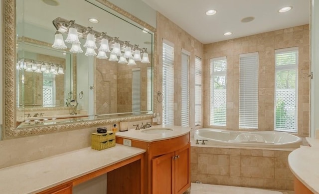 bathroom featuring vanity, recessed lighting, and a bath