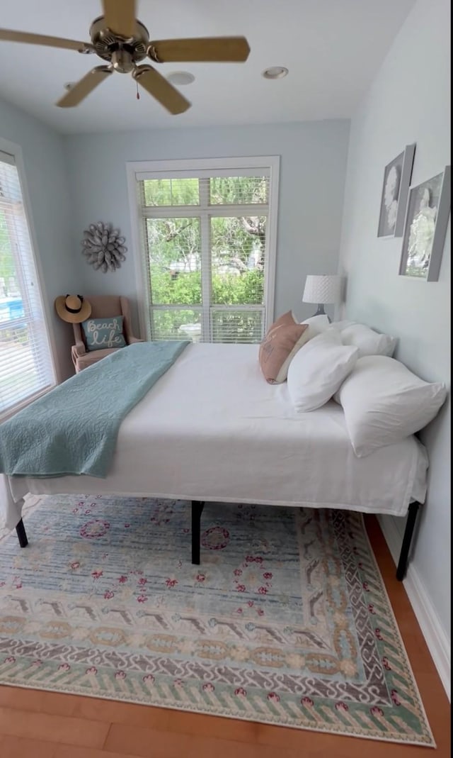 bedroom featuring ceiling fan and wood finished floors