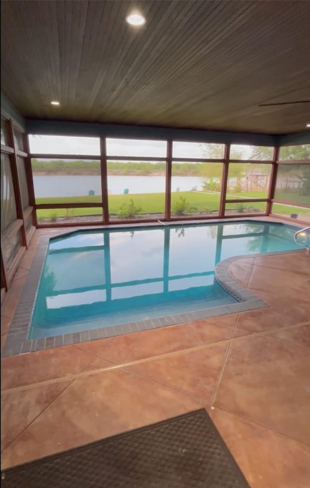 indoor pool with a water view