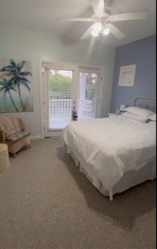 carpeted bedroom with ceiling fan and baseboards