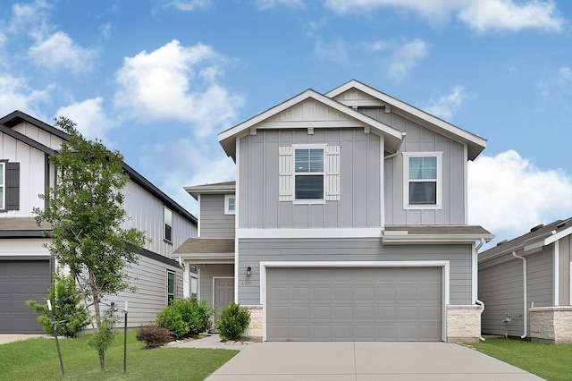 view of front of property featuring board and batten siding, an attached garage, and driveway
