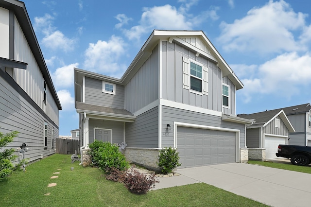 view of front of property with a garage, stone siding, a front yard, board and batten siding, and driveway