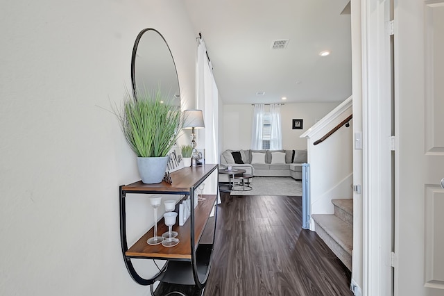 hall with stairway, recessed lighting, dark wood-style flooring, and visible vents