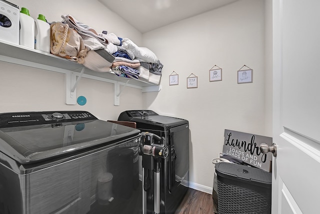 laundry area featuring laundry area, baseboards, dark wood finished floors, and washing machine and dryer