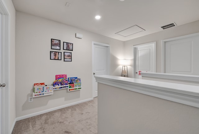 hallway featuring recessed lighting, baseboards, visible vents, and light carpet