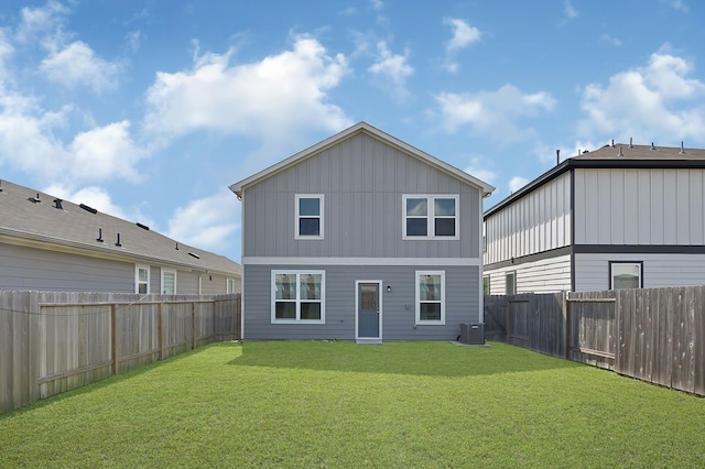 rear view of property featuring a fenced backyard, board and batten siding, central air condition unit, and a yard