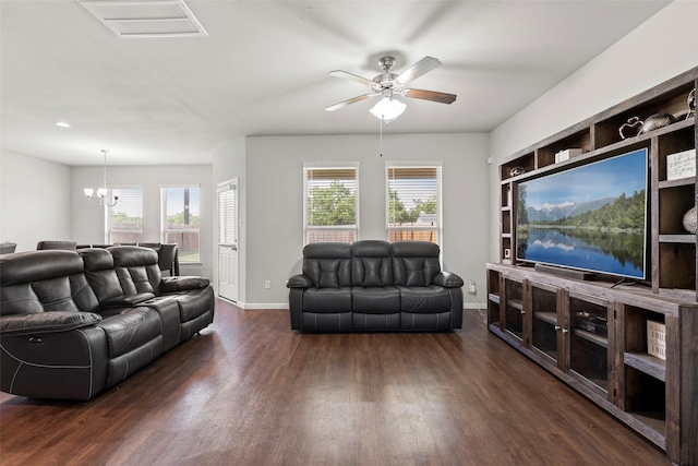 living area featuring visible vents, baseboards, dark wood-type flooring, recessed lighting, and ceiling fan with notable chandelier