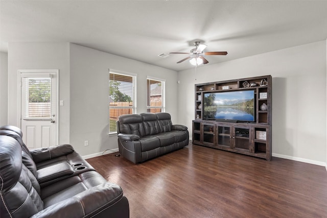 living room with baseboards, ceiling fan, wood finished floors, and visible vents