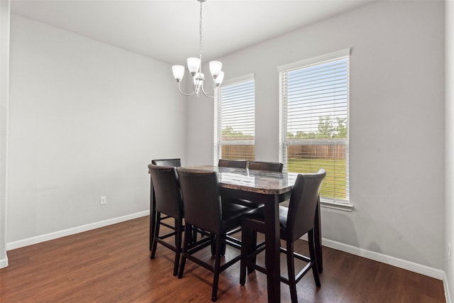dining room with baseboards, an inviting chandelier, and dark wood finished floors