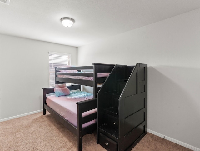 bedroom with baseboards, carpet flooring, and visible vents