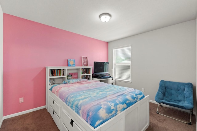 bedroom with baseboards and dark colored carpet