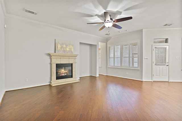 unfurnished living room with crown molding, a ceiling fan, wood finished floors, and visible vents