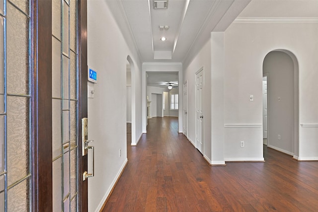 entryway featuring arched walkways, baseboards, visible vents, and wood finished floors