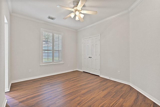 empty room with visible vents, a ceiling fan, dark wood-style flooring, and ornamental molding
