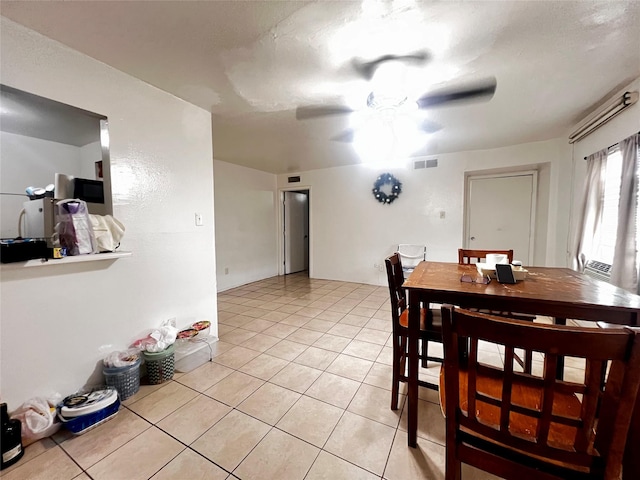 dining area featuring a ceiling fan, visible vents, and light tile patterned floors