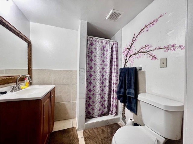 full bathroom featuring vanity, toilet, tile walls, a shower stall, and visible vents
