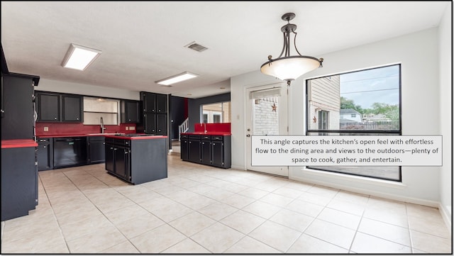 6627 Gleneagles Dr, Pasadena, TX 77505 - kitchen with black dishwasher, dark cabinetry, a sink, and plenty of natural light