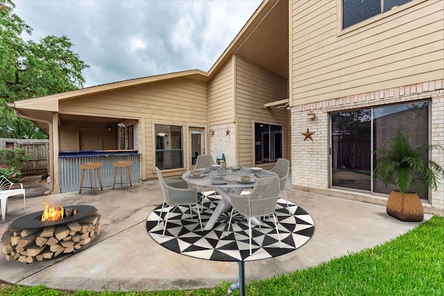 6627 Gleneagles Dr, Pasadena, TX 77505 - view of patio featuring fence, outdoor dry bar, outdoor dining space, and a fire pit