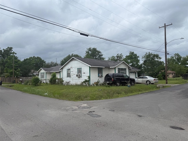 ranch-style home with fence and a front yard