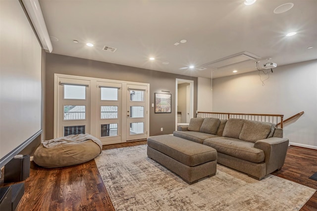 living room with recessed lighting, visible vents, wood finished floors, and attic access