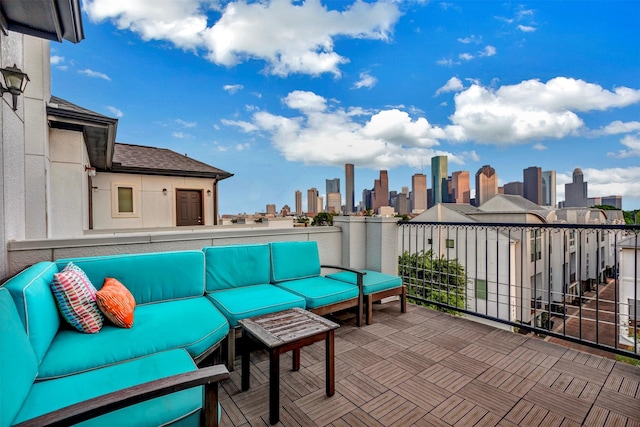 view of patio / terrace with an outdoor hangout area, a city view, and a balcony