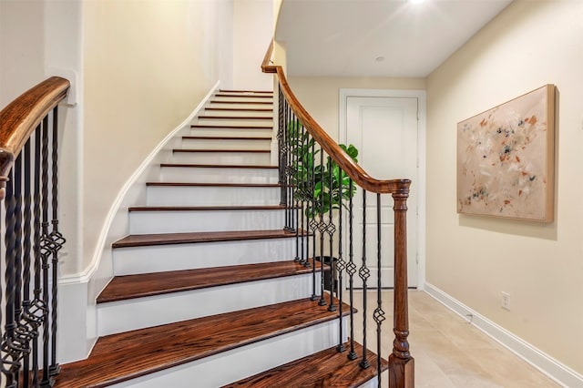 stairway featuring baseboards