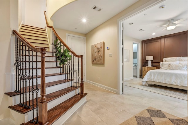 staircase featuring a ceiling fan, baseboards, visible vents, and recessed lighting