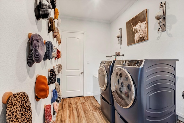 6006 Henry Hamlet Dr, Conroe, TX 77304 - washroom with washing machine and dryer, ornamental molding, and light wood-type flooring