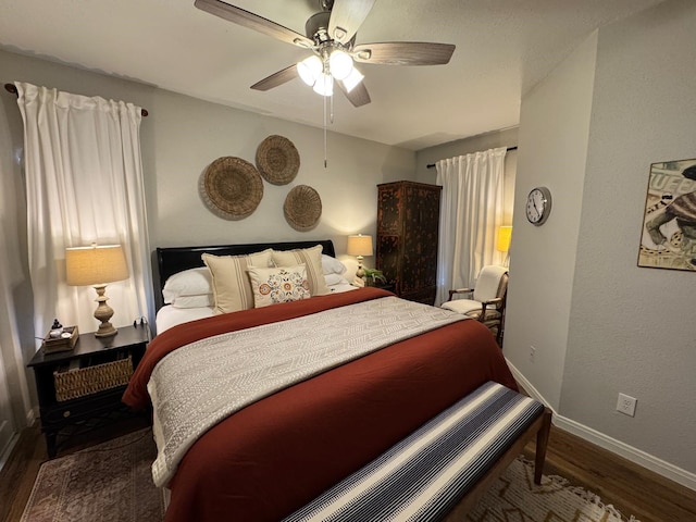bedroom with baseboards, a ceiling fan, and wood finished floors