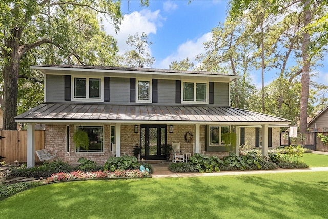 view of front facade with a standing seam roof, a porch, and metal roof