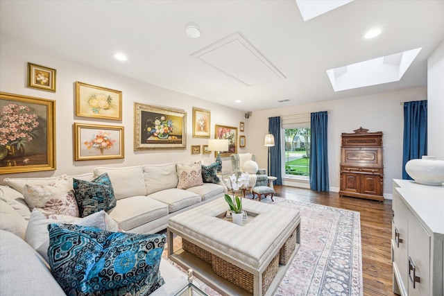 living area with a skylight, attic access, recessed lighting, and wood finished floors