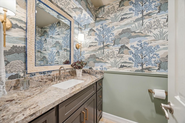 bathroom with vanity and wallpapered walls