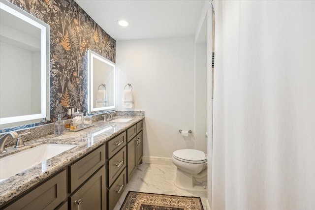 bathroom with baseboards, a sink, marble finish floor, and toilet