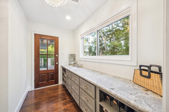 mudroom with baseboards, plenty of natural light, dark wood-style floors, and visible vents