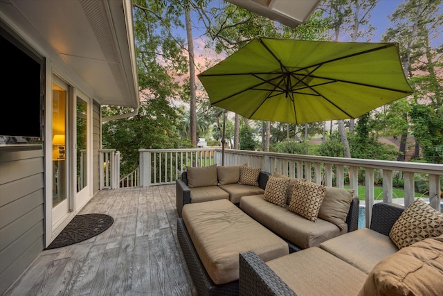 deck at dusk featuring an outdoor hangout area
