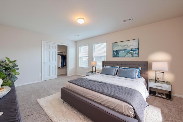 bedroom featuring visible vents, baseboards, carpet floors, and a closet