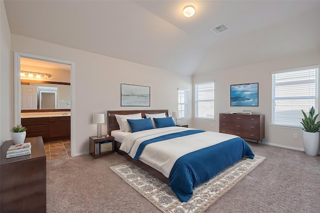bedroom featuring baseboards, visible vents, vaulted ceiling, and light colored carpet