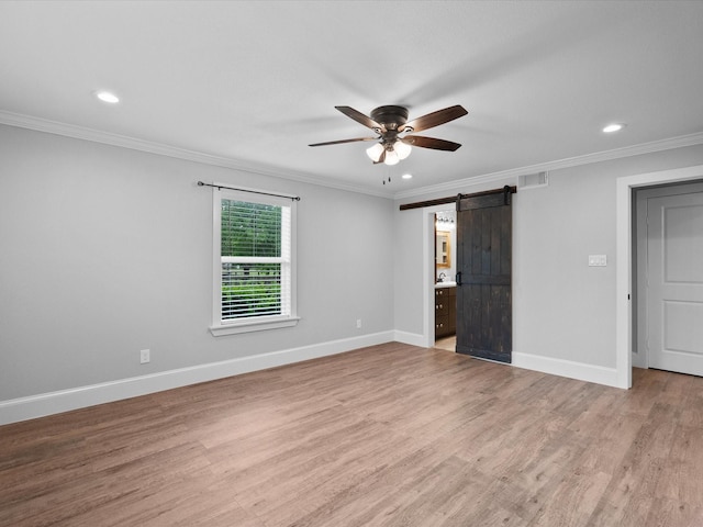 14800 Tallow St, Santa Fe, TX 77517 - spare room featuring ceiling fan, crown molding, a barn door, recessed lighting, and light wood-style flooring
