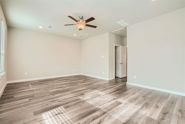 empty room featuring ceiling fan, attic access, recessed lighting, baseboards, and visible vents