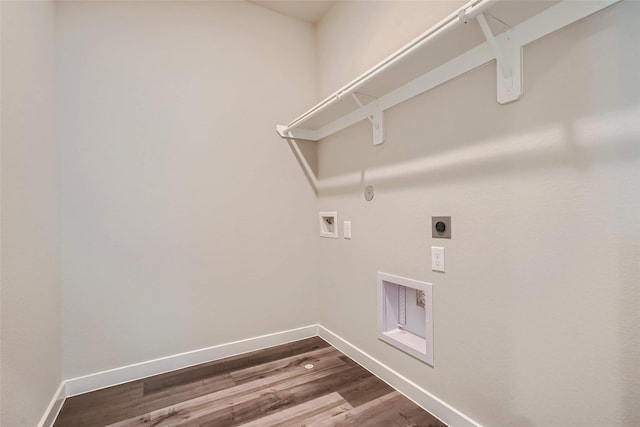 clothes washing area with laundry area, electric dryer hookup, baseboards, hookup for a washing machine, and dark wood-type flooring