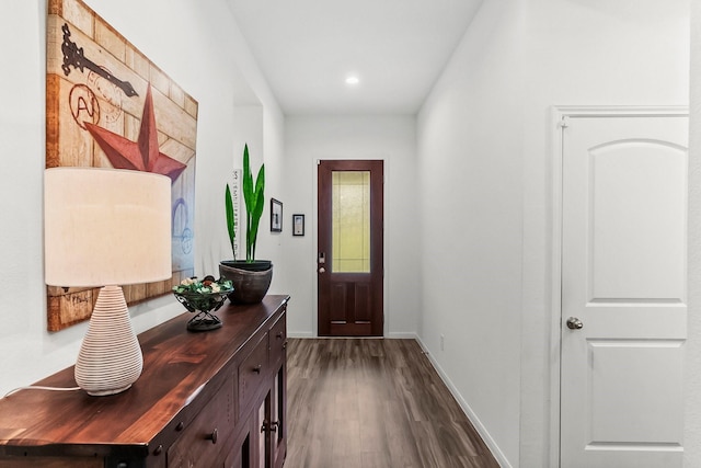 doorway to outside featuring baseboards, recessed lighting, and dark wood-type flooring