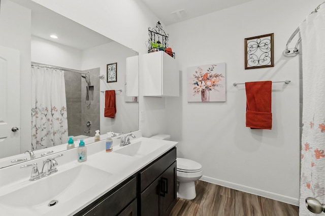 bathroom with a shower with shower curtain, toilet, a sink, and wood finished floors